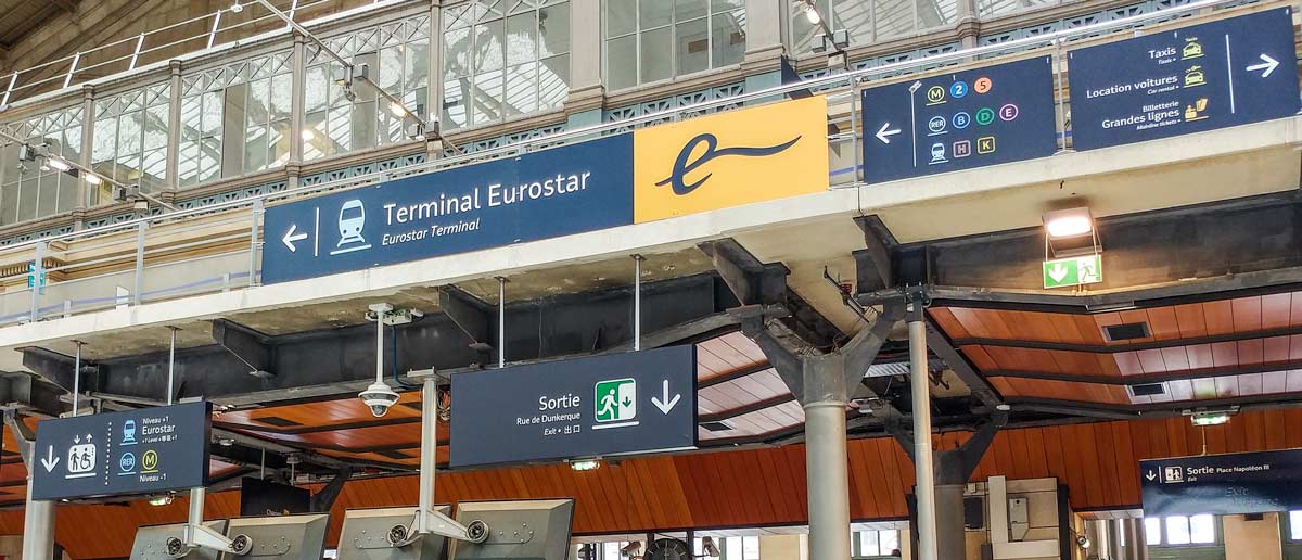 Eurostar arrivals area with signs detail to Metro/RER in Gare du Nord